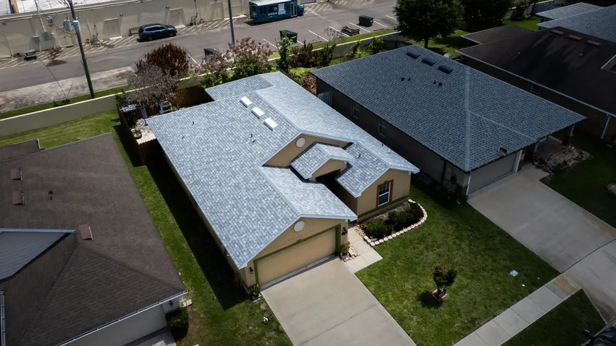 Aerial view of a finished gray shingle roof on a single-story home